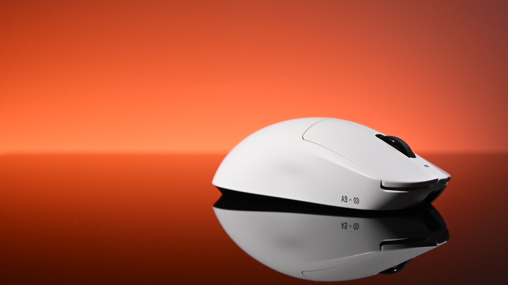 A white gaming mouse rests on a reflective surface against a vibrant red-orange gradient background.