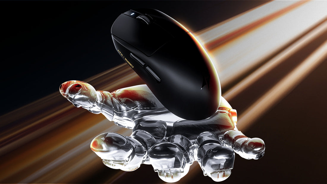 Black gaming mouse with transparent crystal hand sculpture on wooden surface