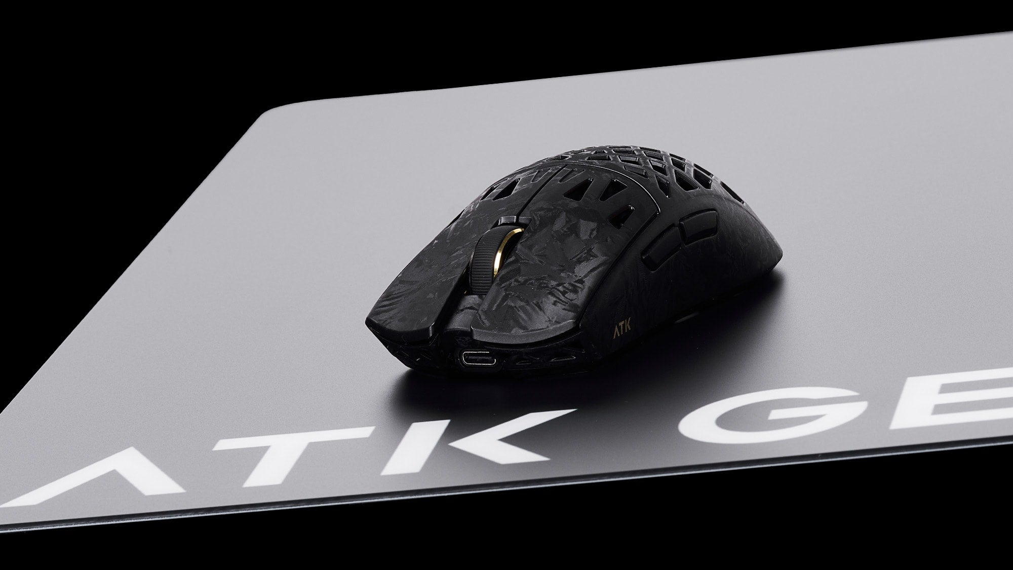 How mouse weight affects comfort: a lightweight honeycomb ATK gaming mouse showcasing an ultra-light design.