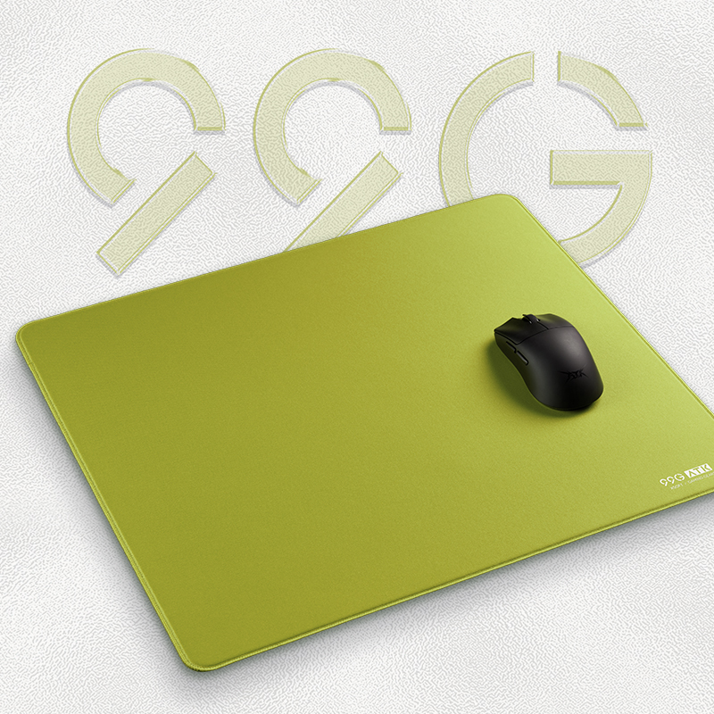 Lime green ATK 99G XSoft eSport gaming mousepad with rounded corners and black gaming mouse on textured background.