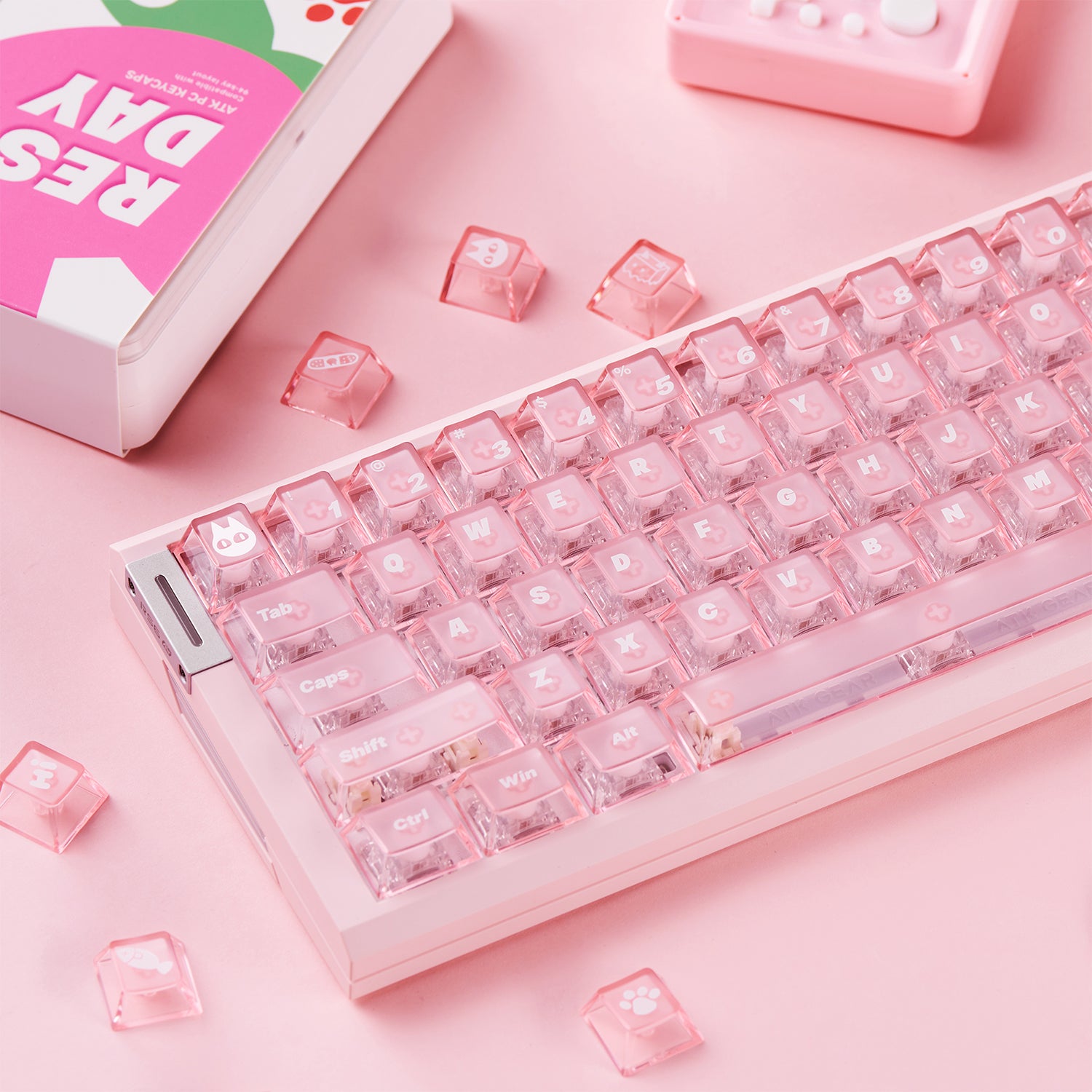 Pink mechanical keyboard with translucent pink keycaps featuring cute icons and "RESP DAY" branding.