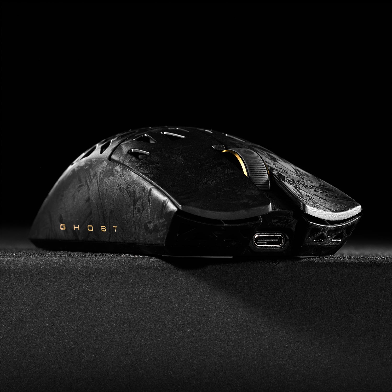 ATK Blazing Sky GHOST hollow carbon fiber wireless gaming mouse with gold scroll wheel and USB-C port.
