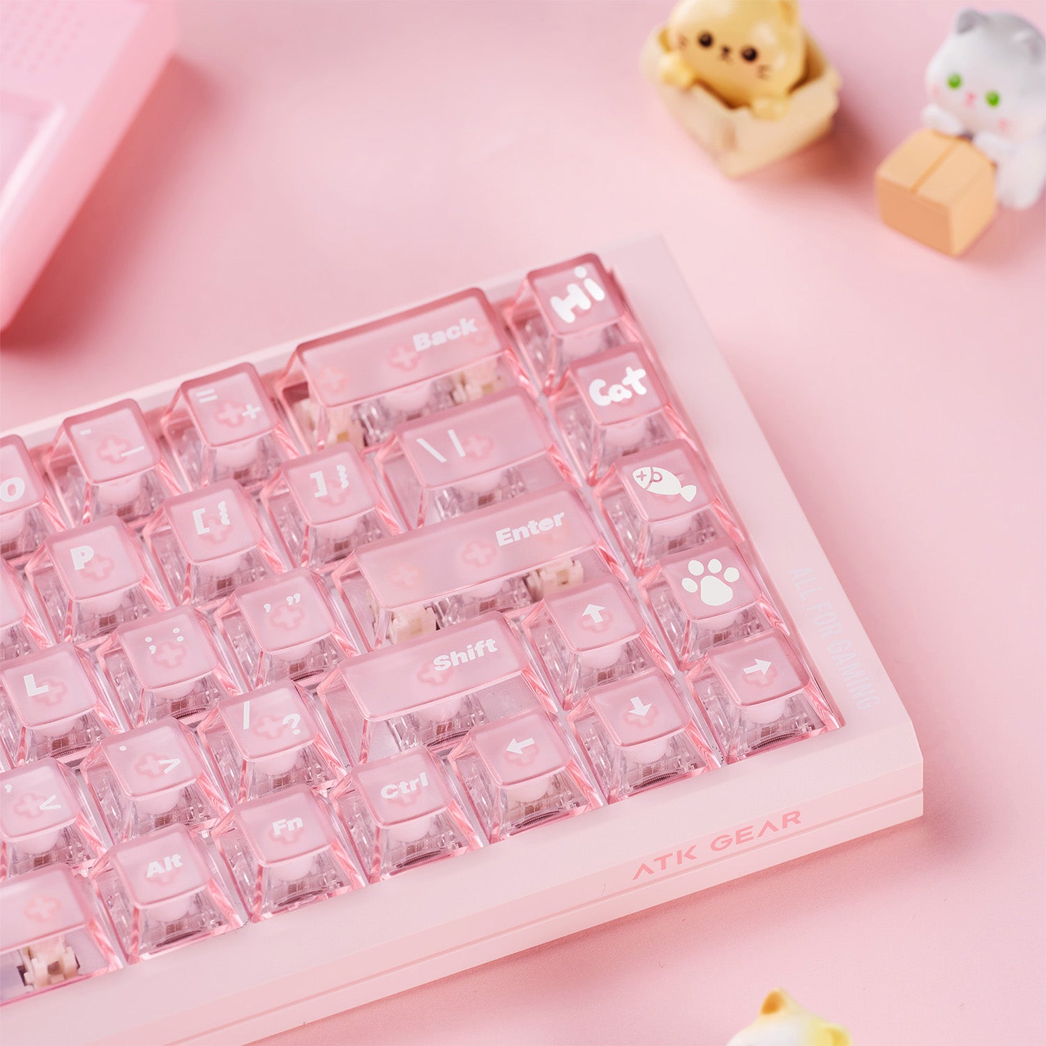 Pink mechanical keyboard with clear pink keycaps. Cat-themed icons, 'Hi', 'Cat', 'Back', 'Shift', 'Ctrl', 'Fn', 'Alt' text. 'ATK GEAR' branding.