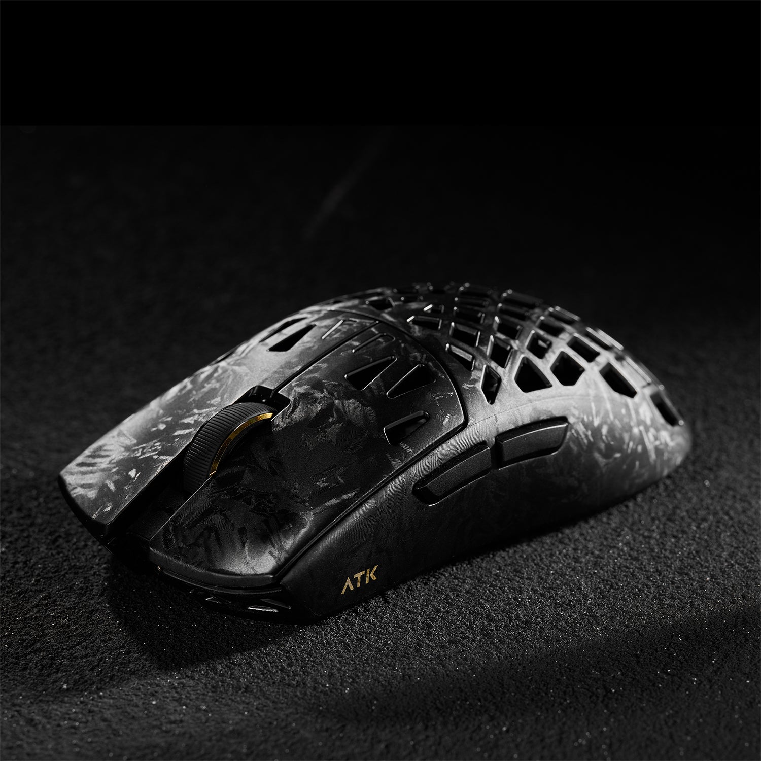 ATK Blazing Sky GHOST wireless gaming mouse with hollow carbon fiber design and gold accents.