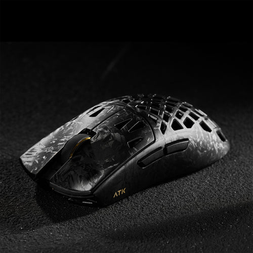 ATK Blazing Sky GHOST wireless gaming mouse with hollow carbon fiber design and gold accents.