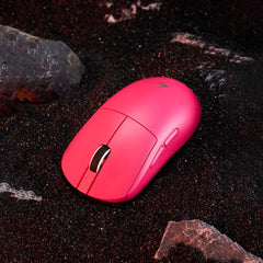 Vibrant pink ATK Dragonfly A9 wireless gaming mouse with matte finish and subtle lightning logo on dark sand.