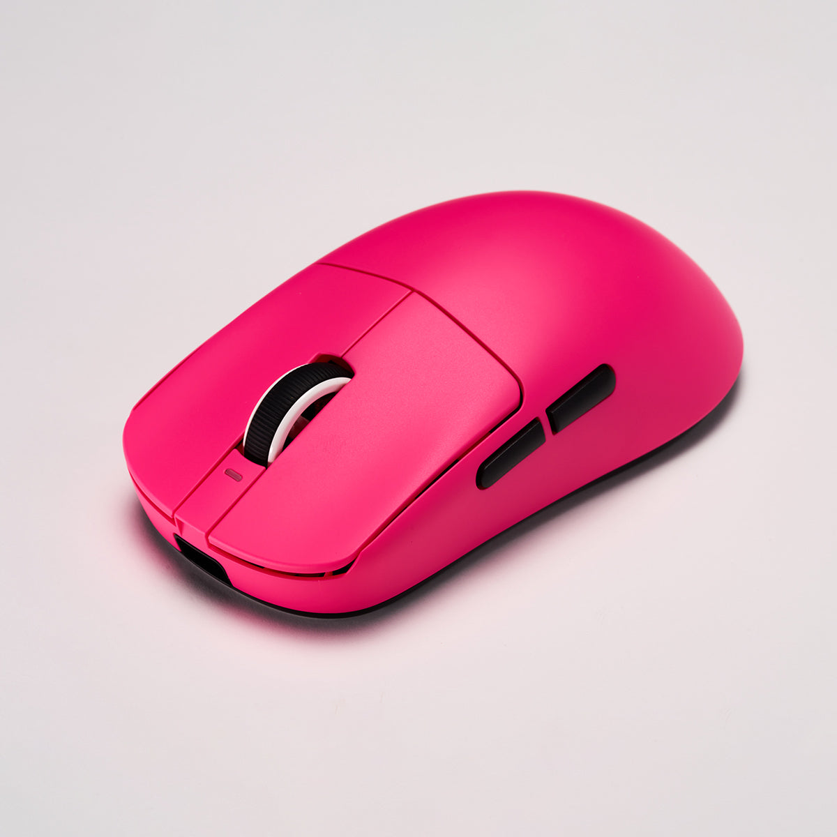 VXE Dragonfly R1 wireless gaming mouse in vibrant pink, featuring a textured scroll wheel and side buttons.