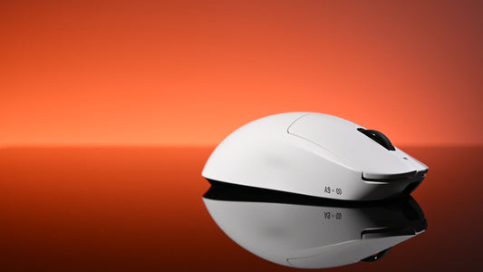 A white gaming mouse rests on a reflective surface against a vibrant red-orange gradient background.