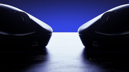 Silhouettes of two sleek gaming mice facing each other on a reflective surface with blue backlight.