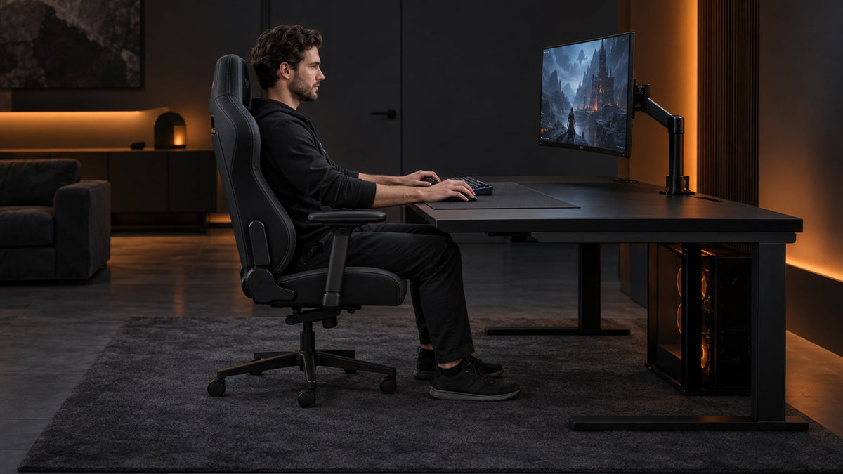 Gamer sitting upright in an ergonomic gaming chair with proper desk height and monitor positioning.