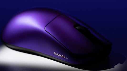 A sleek, purple Duckbill wireless mouse in focus.