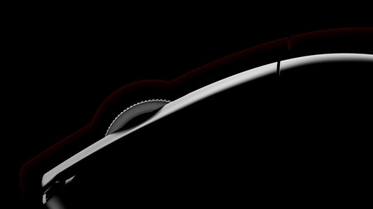 Close-up side view of a black gaming mouse with illuminated scroll wheel against a dark background.