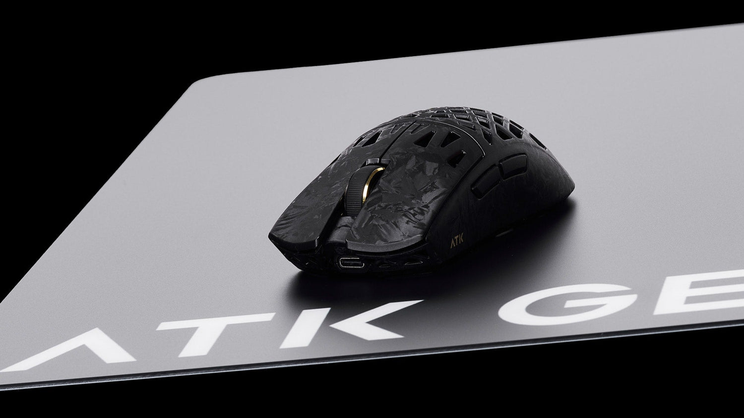 How mouse weight affects comfort: a lightweight honeycomb ATK gaming mouse showcasing an ultra-light design.
