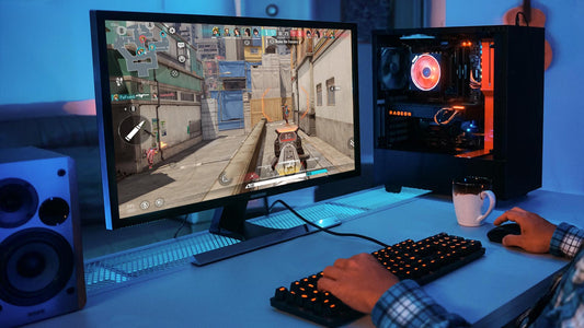 Gamer playing an FPS video game on a desktop PC with a backlit keyboard and RGB-lit tower in a blue-lit room