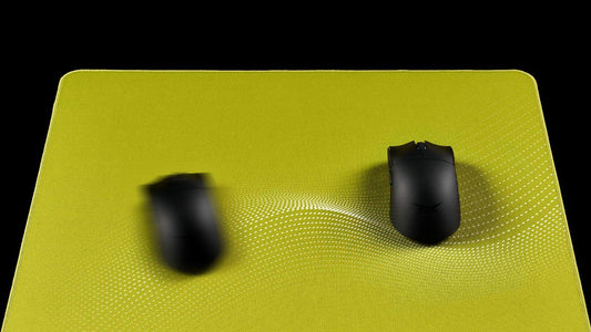 Gaming mousepad with textured surface showing a wavy indentation beneath a stationary mouse