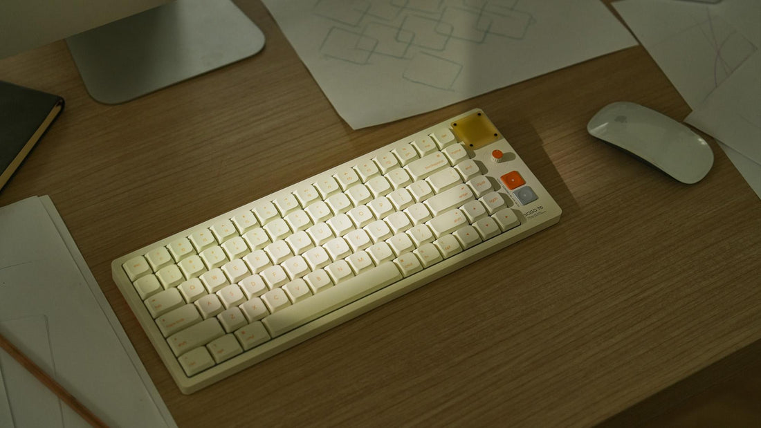 Minimal desk setup with a compact mechanical keyboard, mouse, and soft lighting on a wooden desktop