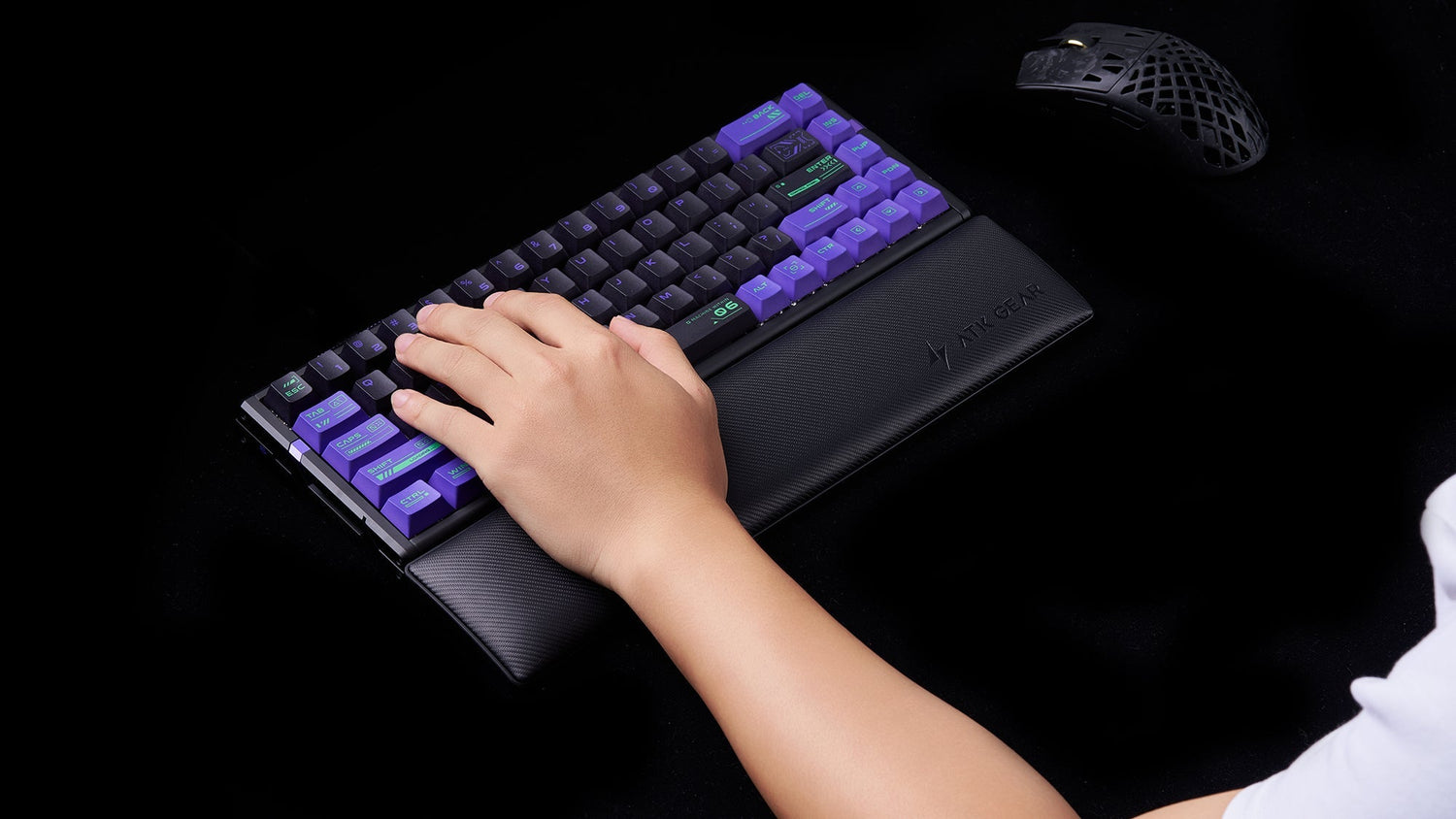 Person using ATK GEAR wrist rest with mechanical gaming keyboard featuring purple keycaps