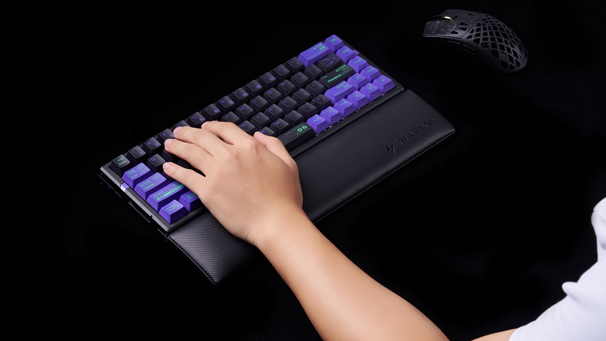 Person using ATK GEAR wrist rest with mechanical gaming keyboard featuring purple keycaps
