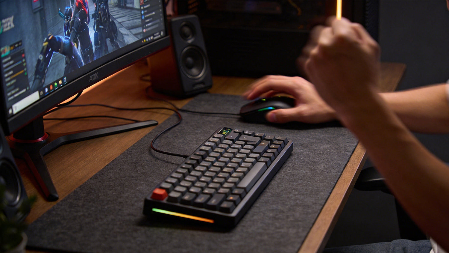 Hands using a compact mechanical keyboard and mouse during PC gaming