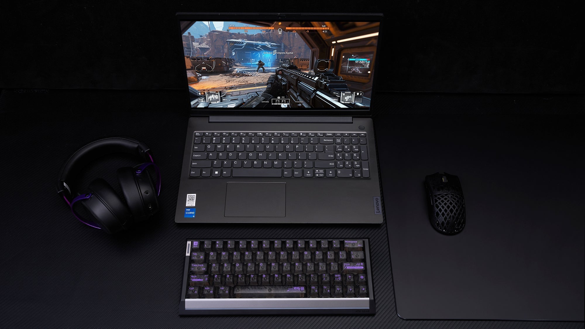 Laptop gaming setup with external ATK mechanical keyboard, gaming mouse, and headset on desk