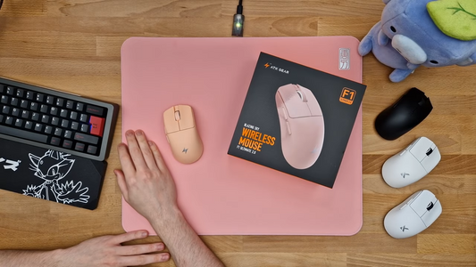 Pink ATK mousepad with wireless mice and keyboard on desk