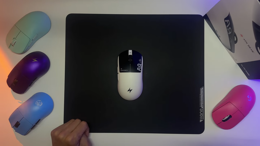 ATK A10 wireless gaming mouse on a black mousepad with colorful mice around it