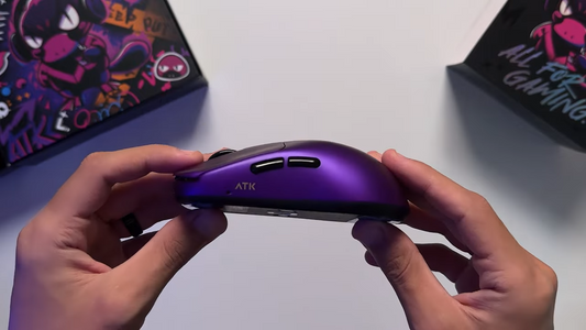 Hands holding the purple ATK Duck Bill gaming mouse side profile
