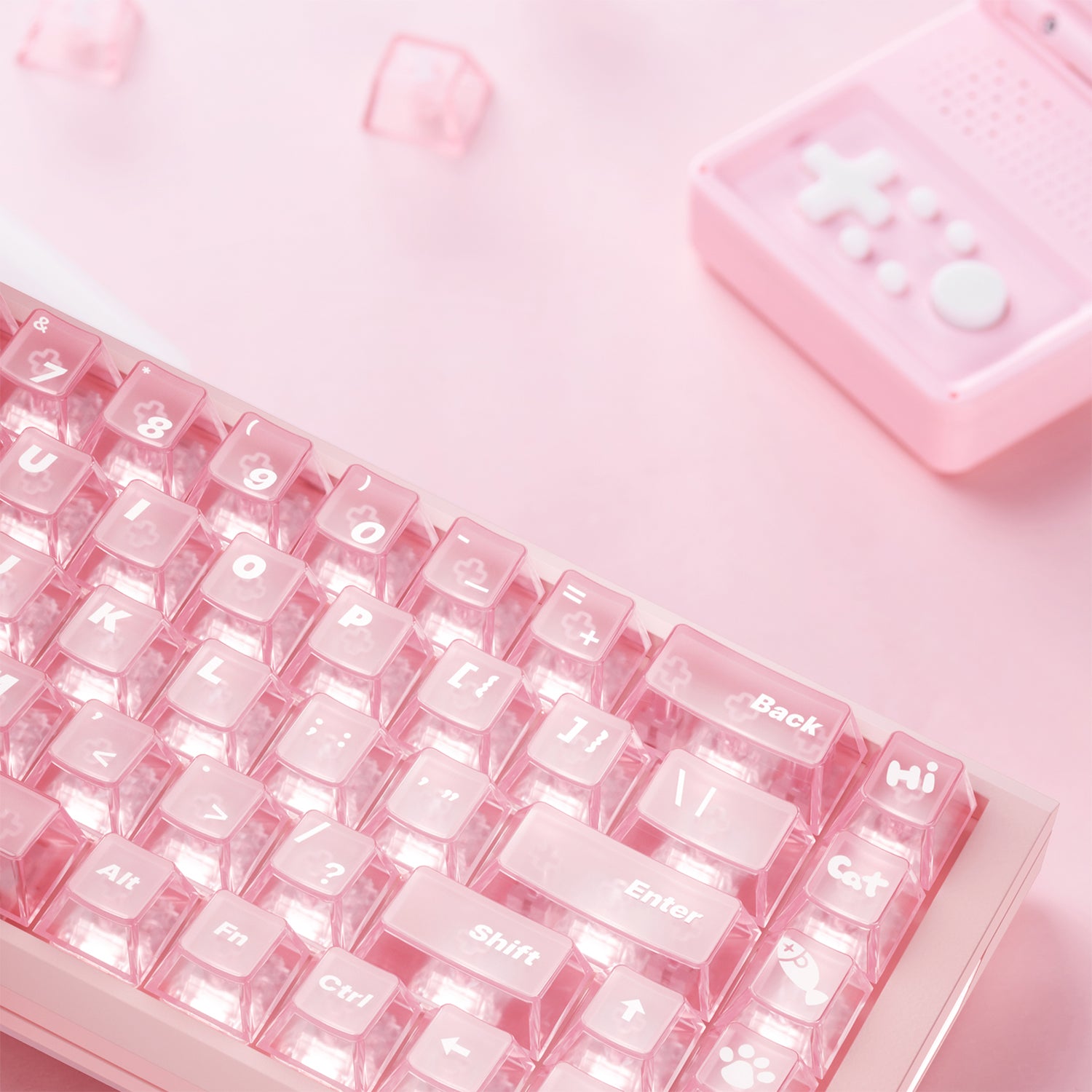 Pink mechanical keyboard with translucent keycaps, featuring 'Cat' and paw print designs.