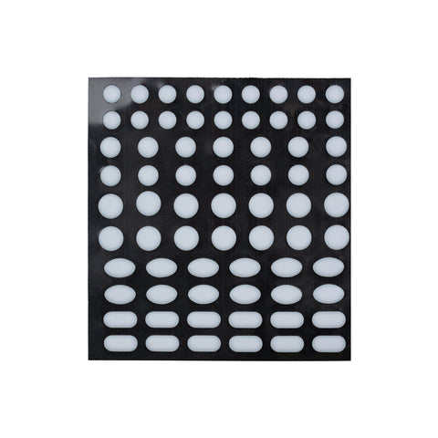 Sheet of round and oval white adhesive pads on a black backing.