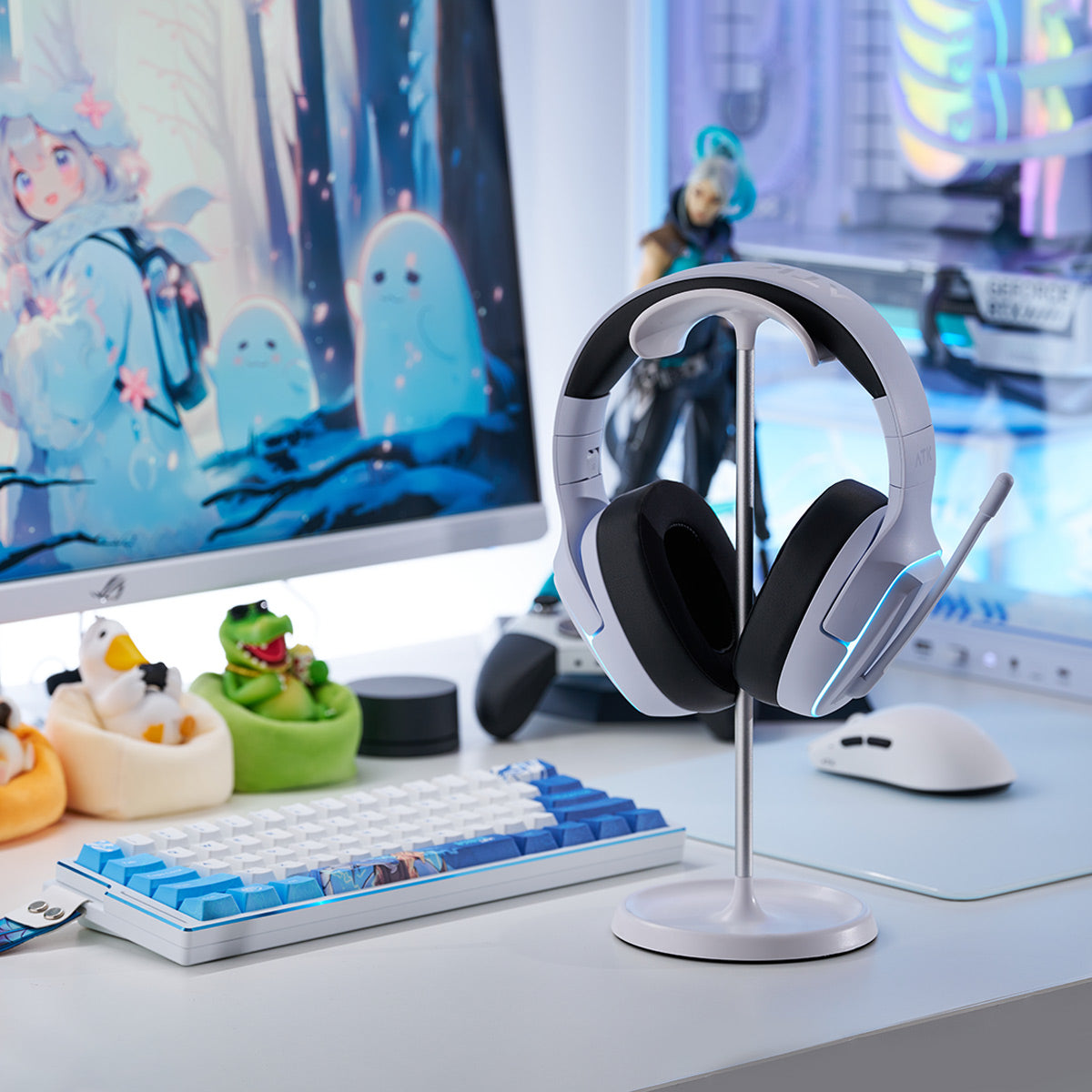 White gaming headset with black earcups on a stand, next to a white keyboard and mouse.