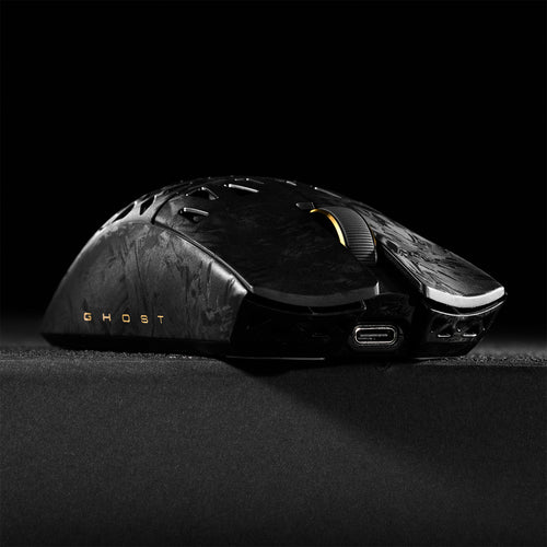 ATK Blazing Sky GHOST hollow carbon fiber wireless gaming mouse with gold scroll wheel and USB-C port.